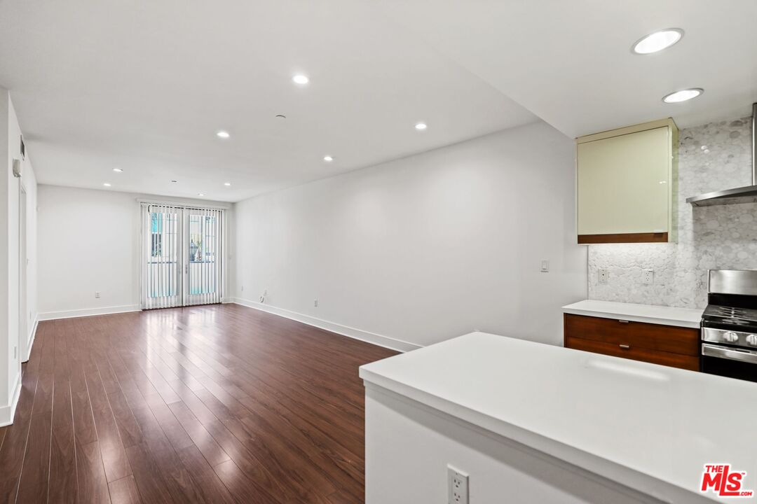 220 East Broadway, Unit 202 Glendale, CA 91205 - Photo 7 of 13 a view of kitchen and empty room with wooden floor