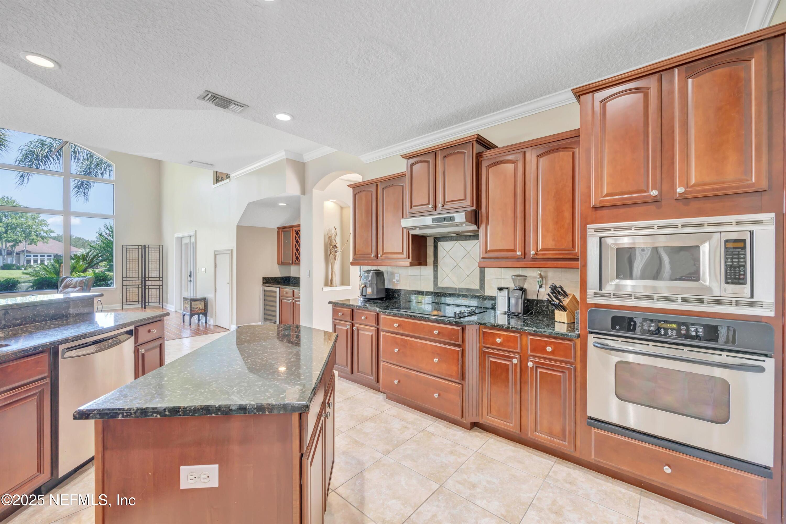 168 Pinehurst Pointe Drive St. Augustine, FL 32092 - Photo 15 of 72 a kitchen with stainless steel appliances granite countertop a stove sink and cabinets