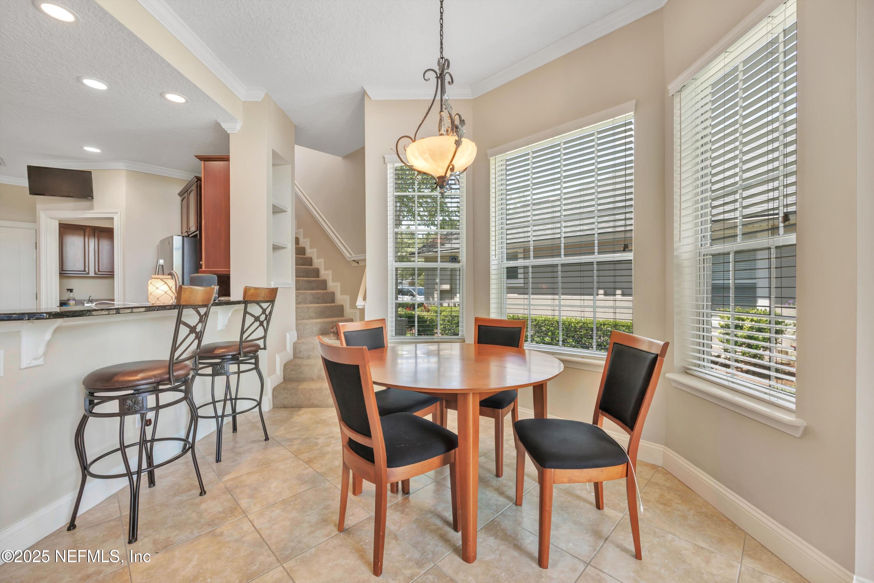 168 Pinehurst Pointe Drive St. Augustine, FL 32092 - Photo 23 of 72 a dining room with furniture and window