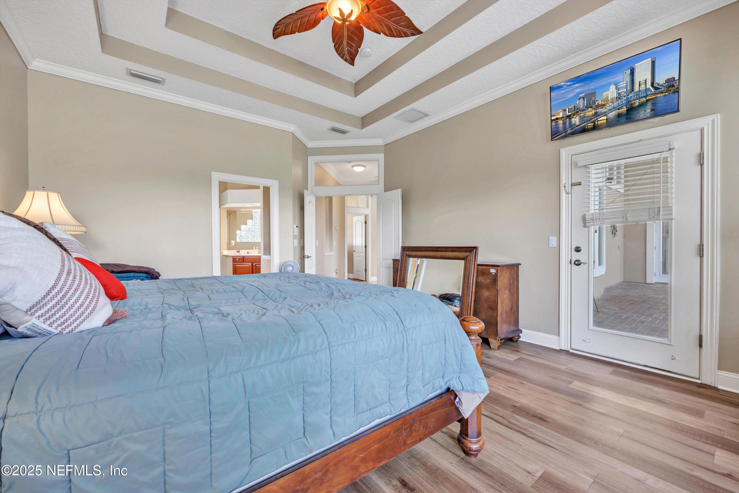 168 Pinehurst Pointe Drive St. Augustine, FL 32092 - Photo 24 of 72 a bedroom with a bed and a chandelier