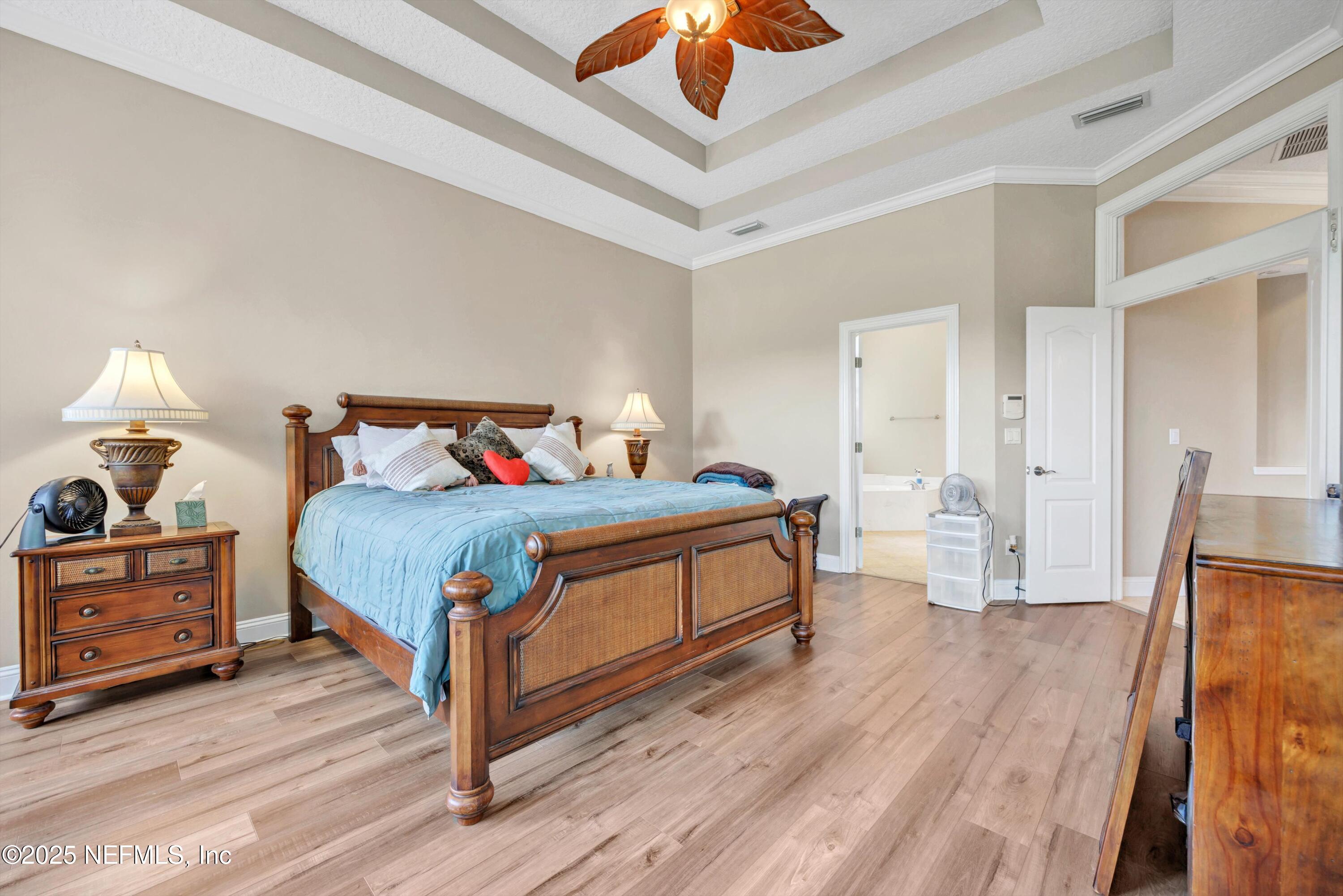 168 Pinehurst Pointe Drive St. Augustine, FL 32092 - Photo 26 of 72 a bedroom with a bed and wooden floor