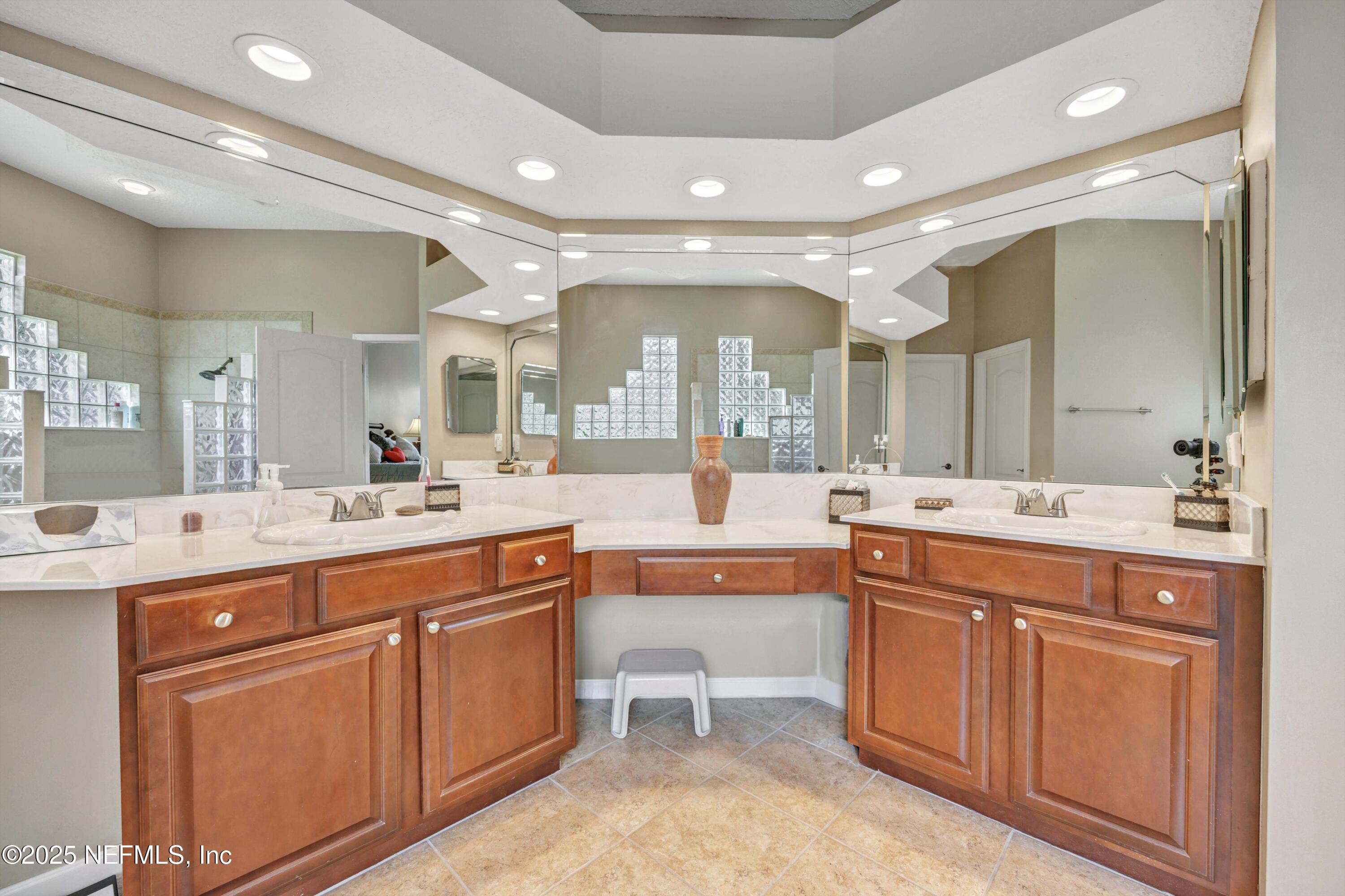 168 Pinehurst Pointe Drive St. Augustine, FL 32092 - Photo 29 of 72 a large bathroom with a large mirror vanity and shower