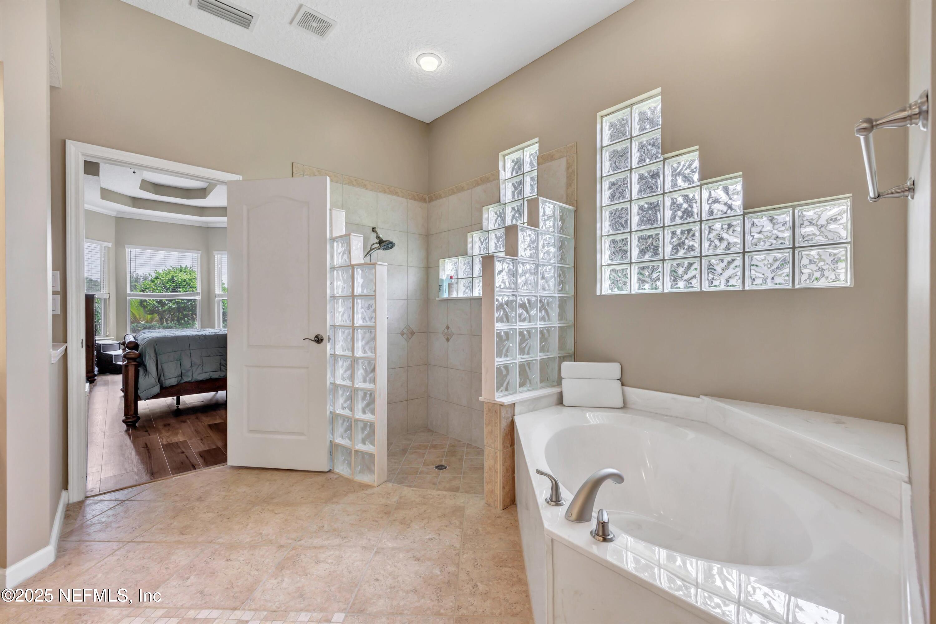 168 Pinehurst Pointe Drive St. Augustine, FL 32092 - Photo 30 of 72 a bathroom with a bathtub and a shower