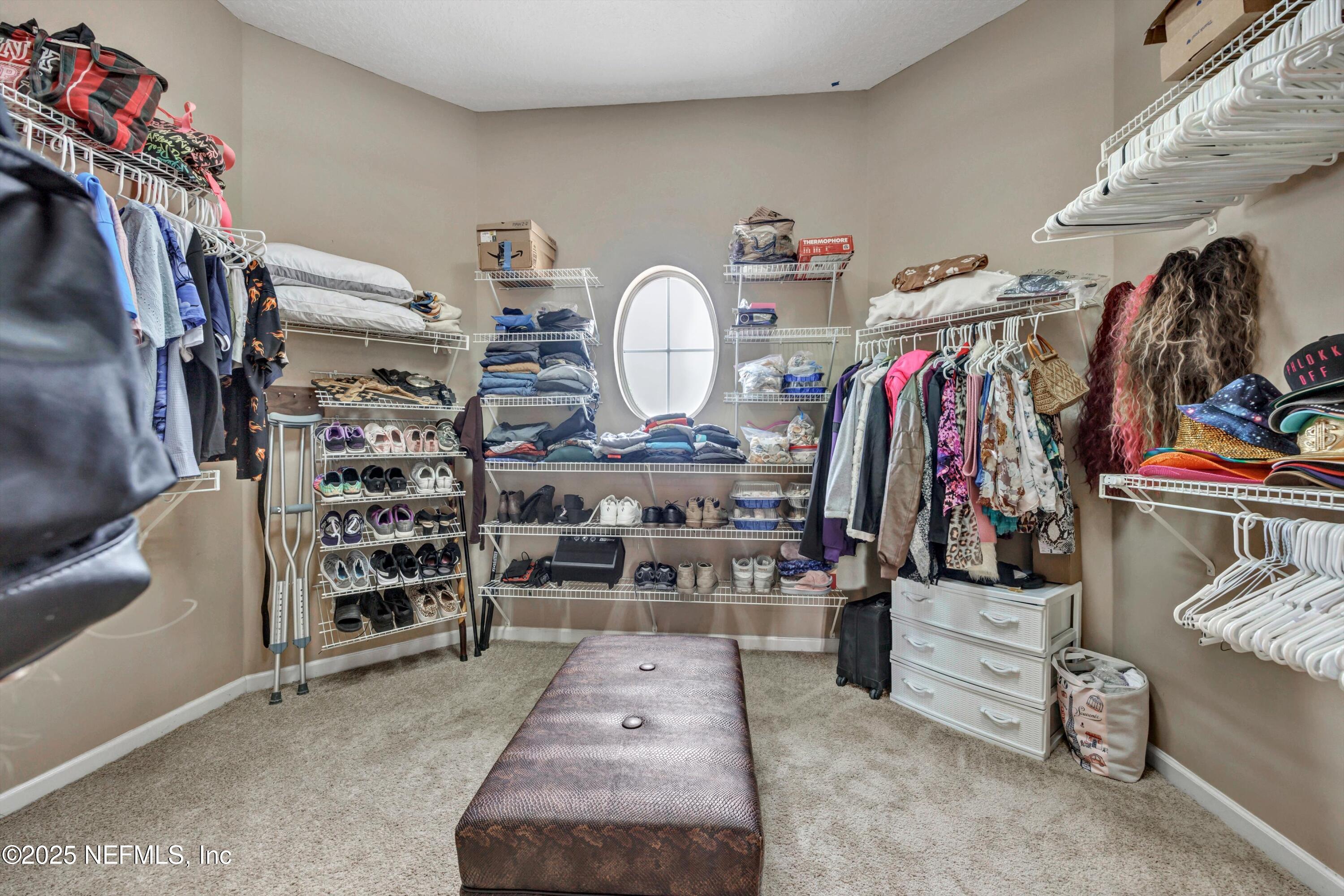 168 Pinehurst Pointe Drive St. Augustine, FL 32092 - Photo 31 of 72 a view of walk in closet with clothes and shoes