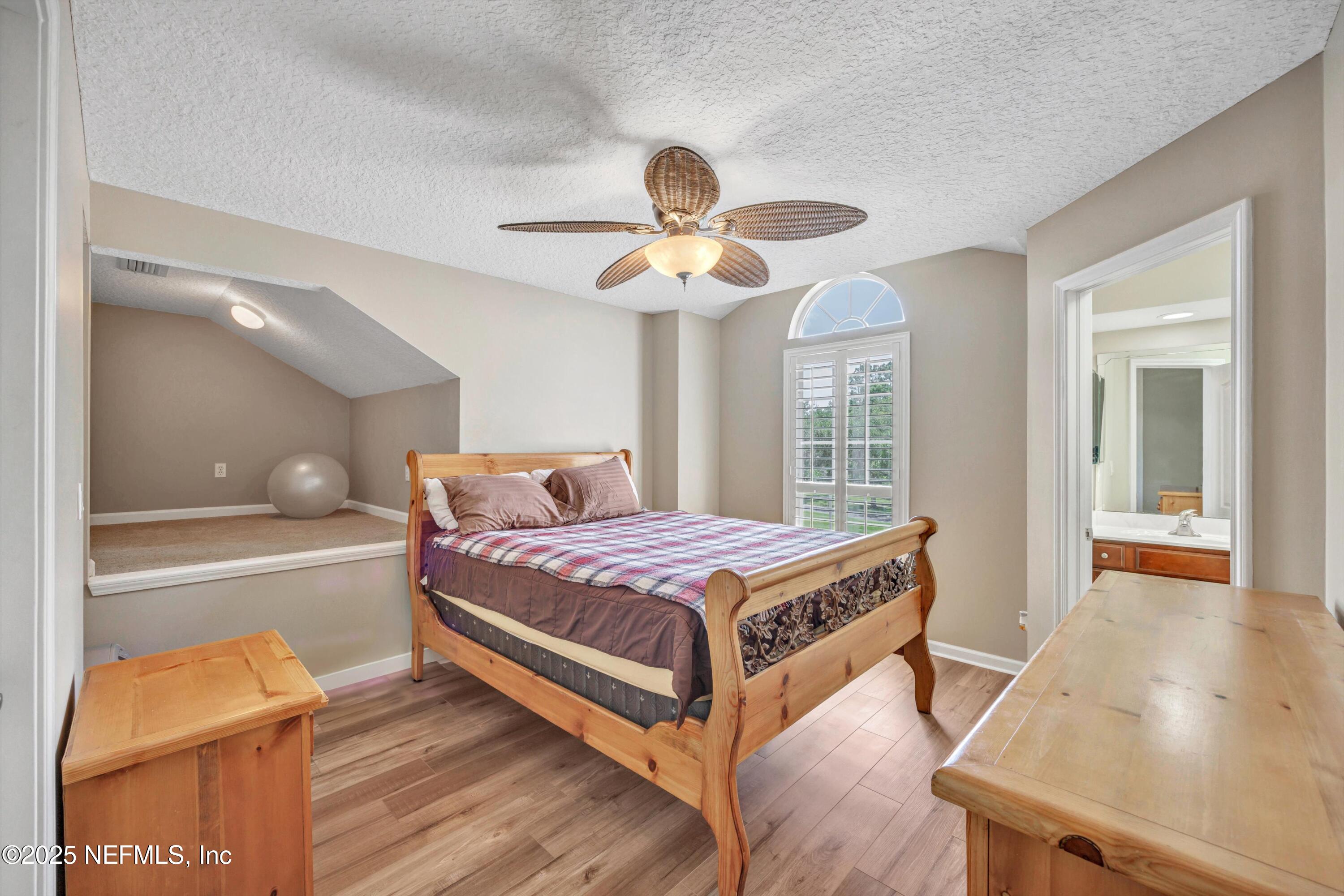 168 Pinehurst Pointe Drive St. Augustine, FL 32092 - Photo 35 of 72 a bedroom with a bed and a chandelier