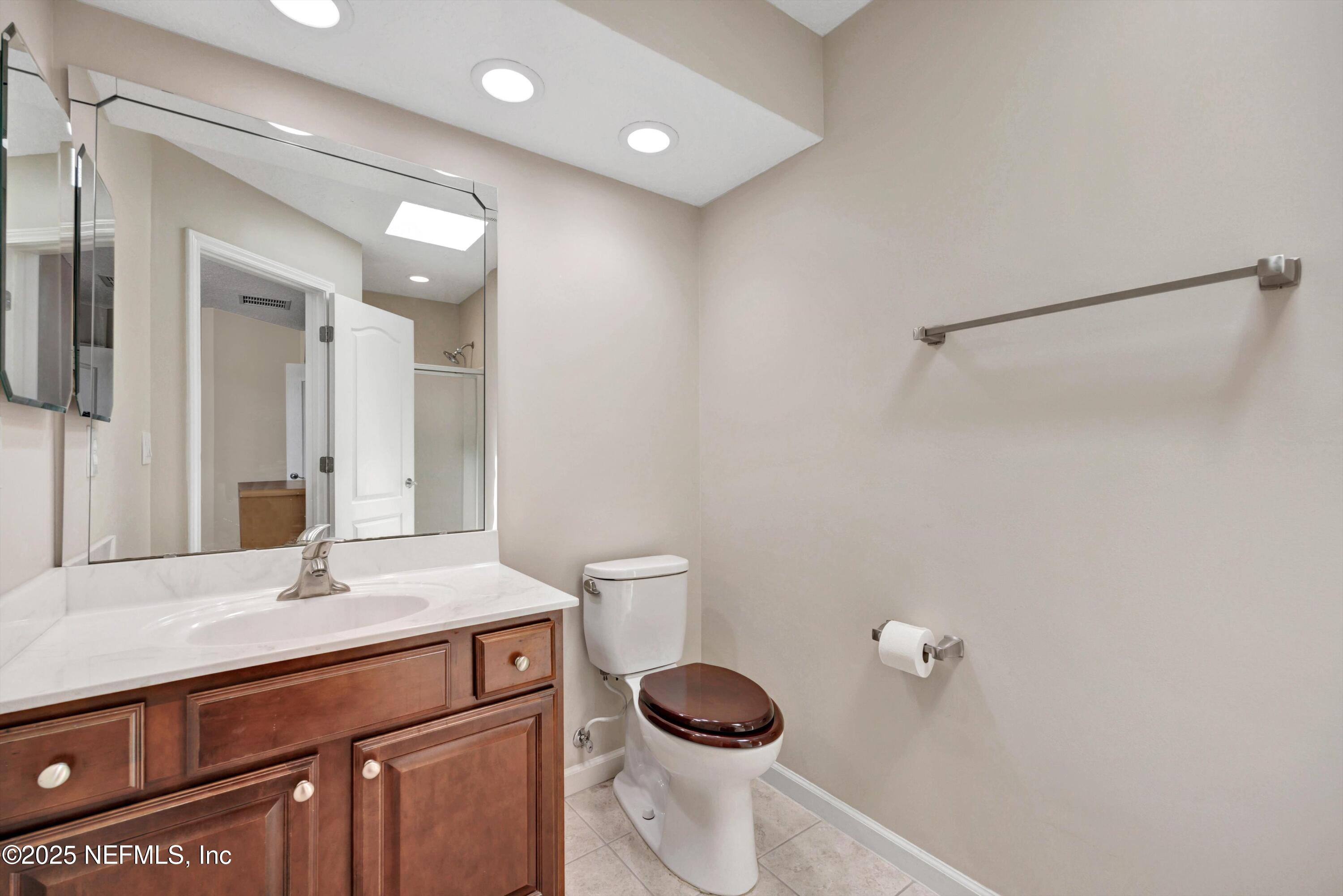 168 Pinehurst Pointe Drive St. Augustine, FL 32092 - Photo 37 of 72 a bathroom with a toilet a sink and mirror