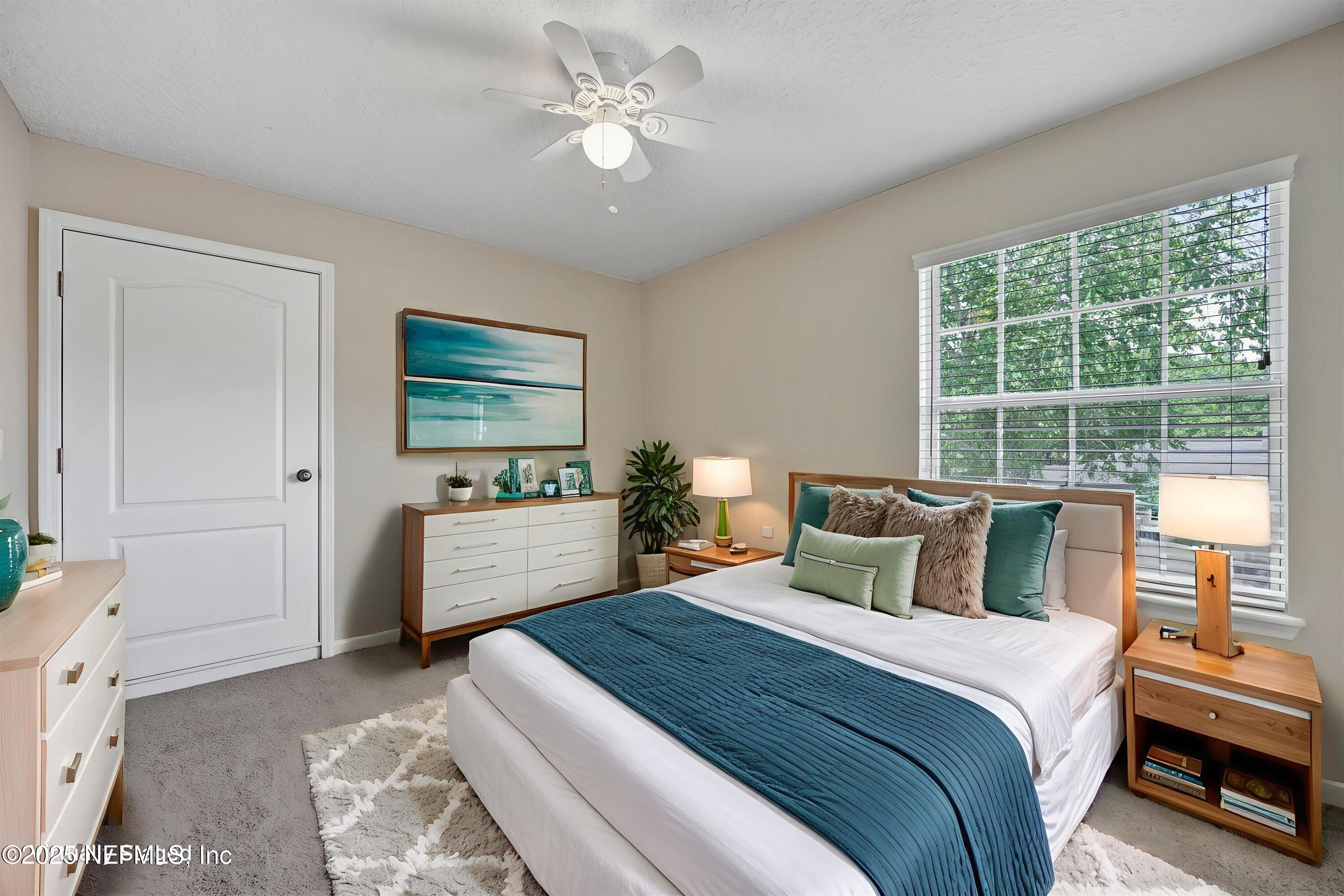 168 Pinehurst Pointe Drive St. Augustine, FL 32092 - Photo 43 of 72 a bedroom with a large bed and a chandelier