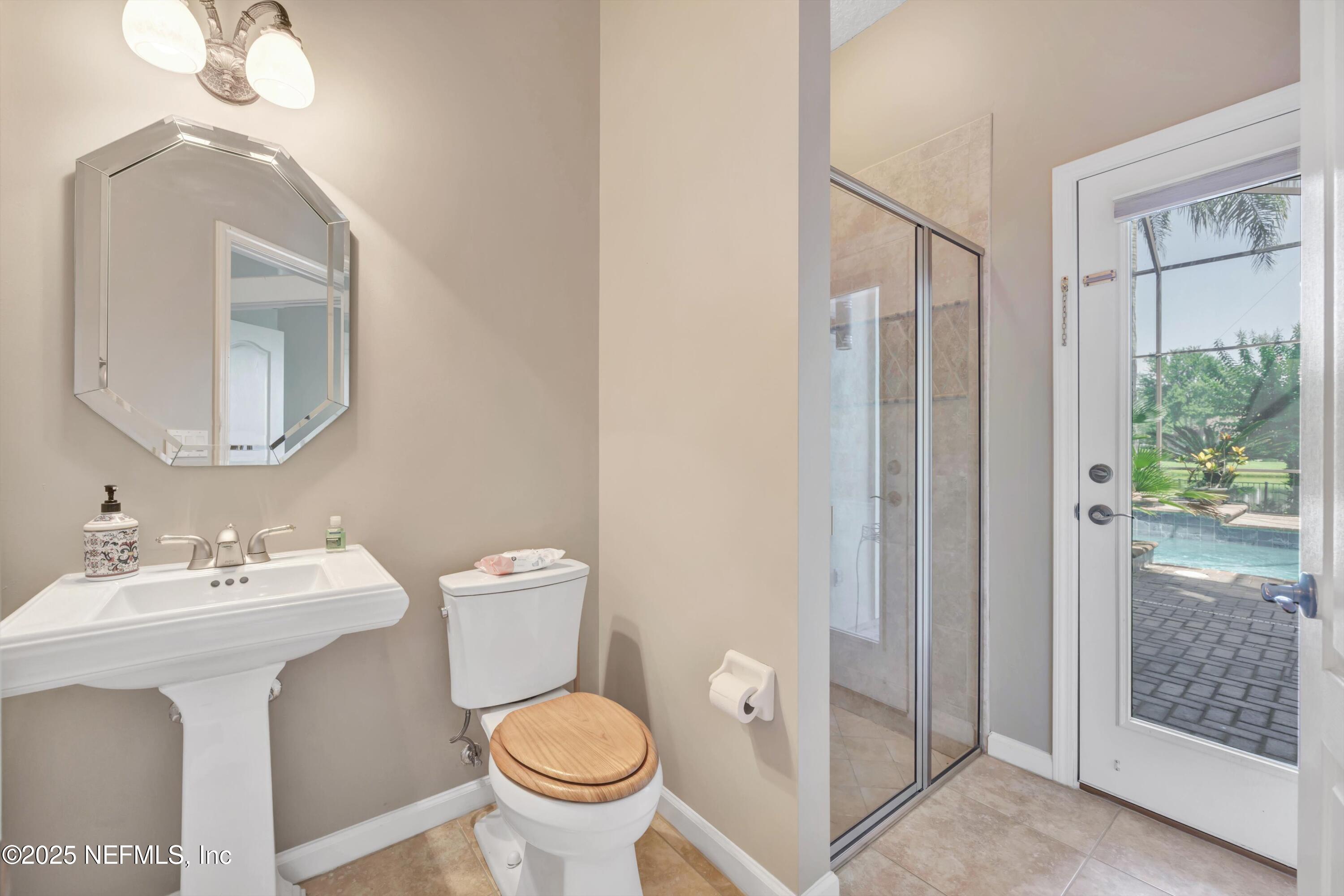 168 Pinehurst Pointe Drive St. Augustine, FL 32092 - Photo 58 of 72 a bathroom with a toilet sink and mirror