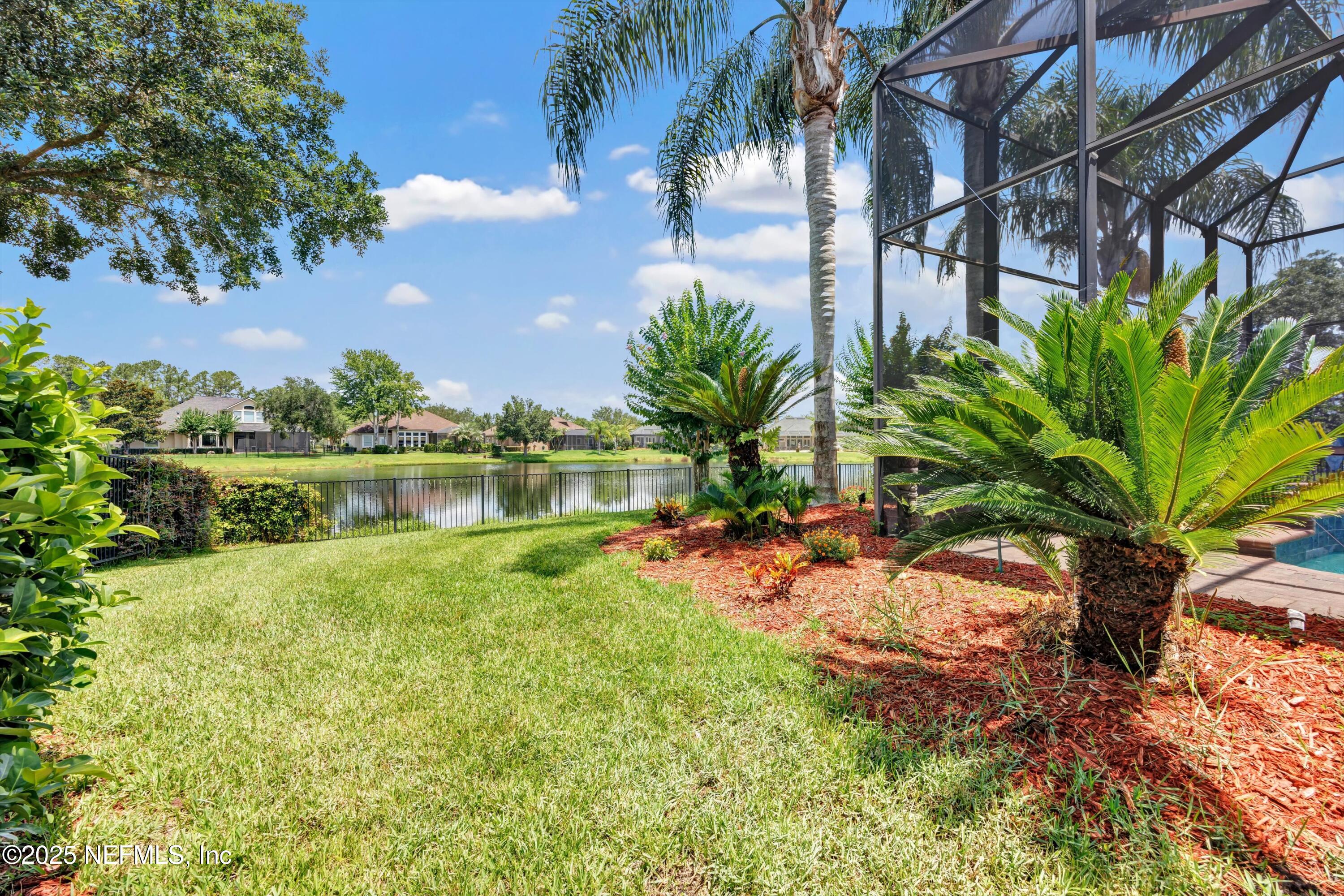 168 Pinehurst Pointe Drive St. Augustine, FL 32092 - Photo 60 of 72 a backyard of a house with a garden and outdoor seating