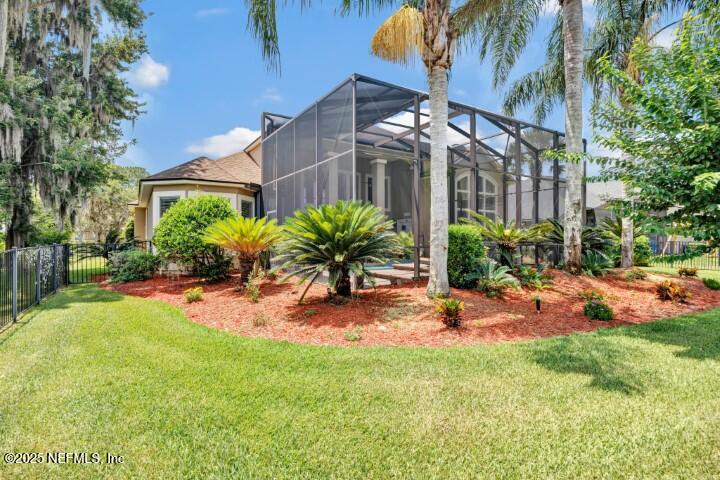 168 Pinehurst Pointe Drive St. Augustine, FL 32092 - Photo 66 of 72 a view of a backyard with plants and a patio