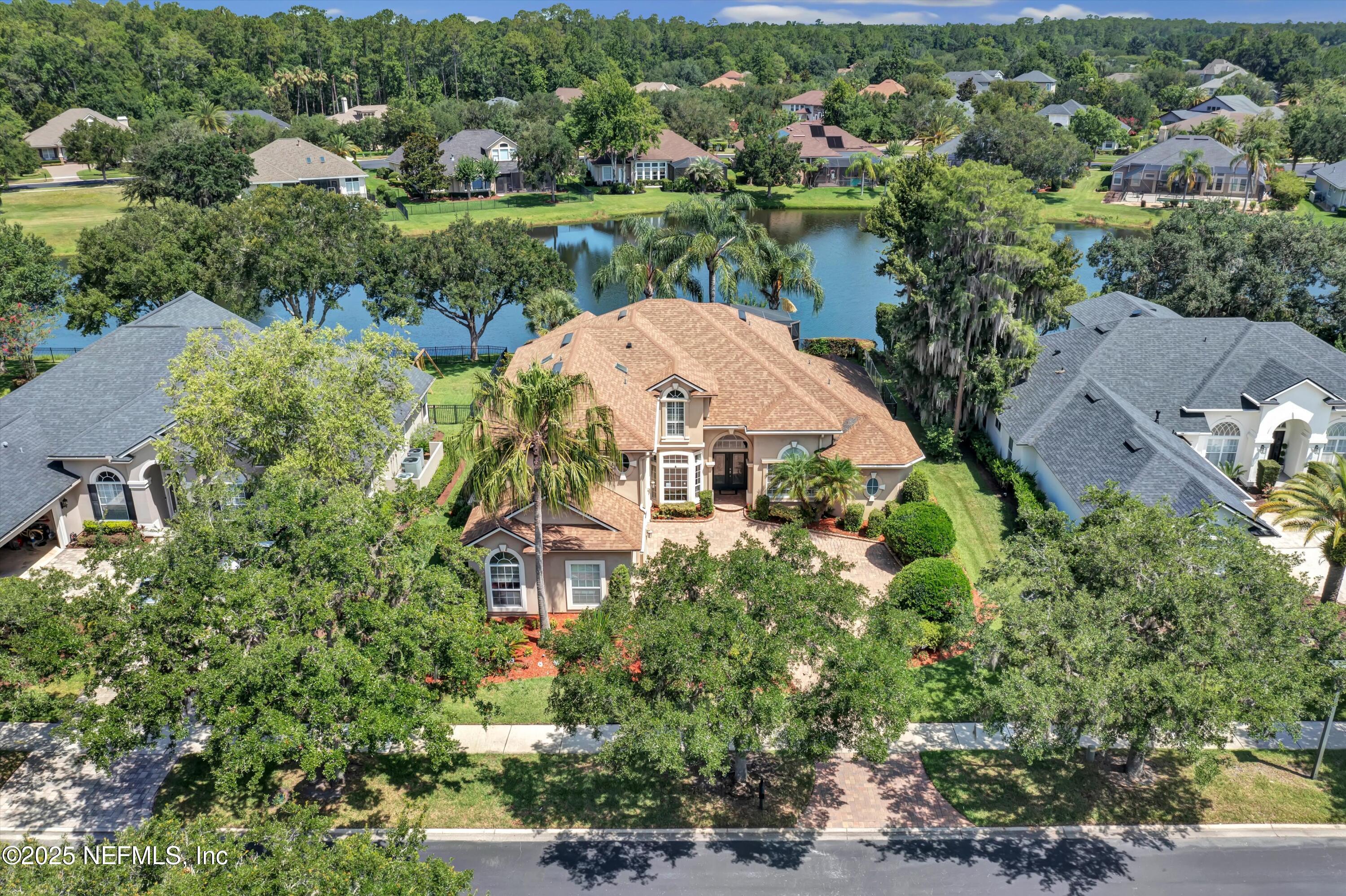 168 Pinehurst Pointe Drive St. Augustine, FL 32092 - Photo 68 of 72 an aerial view of a house with a yard and lake view