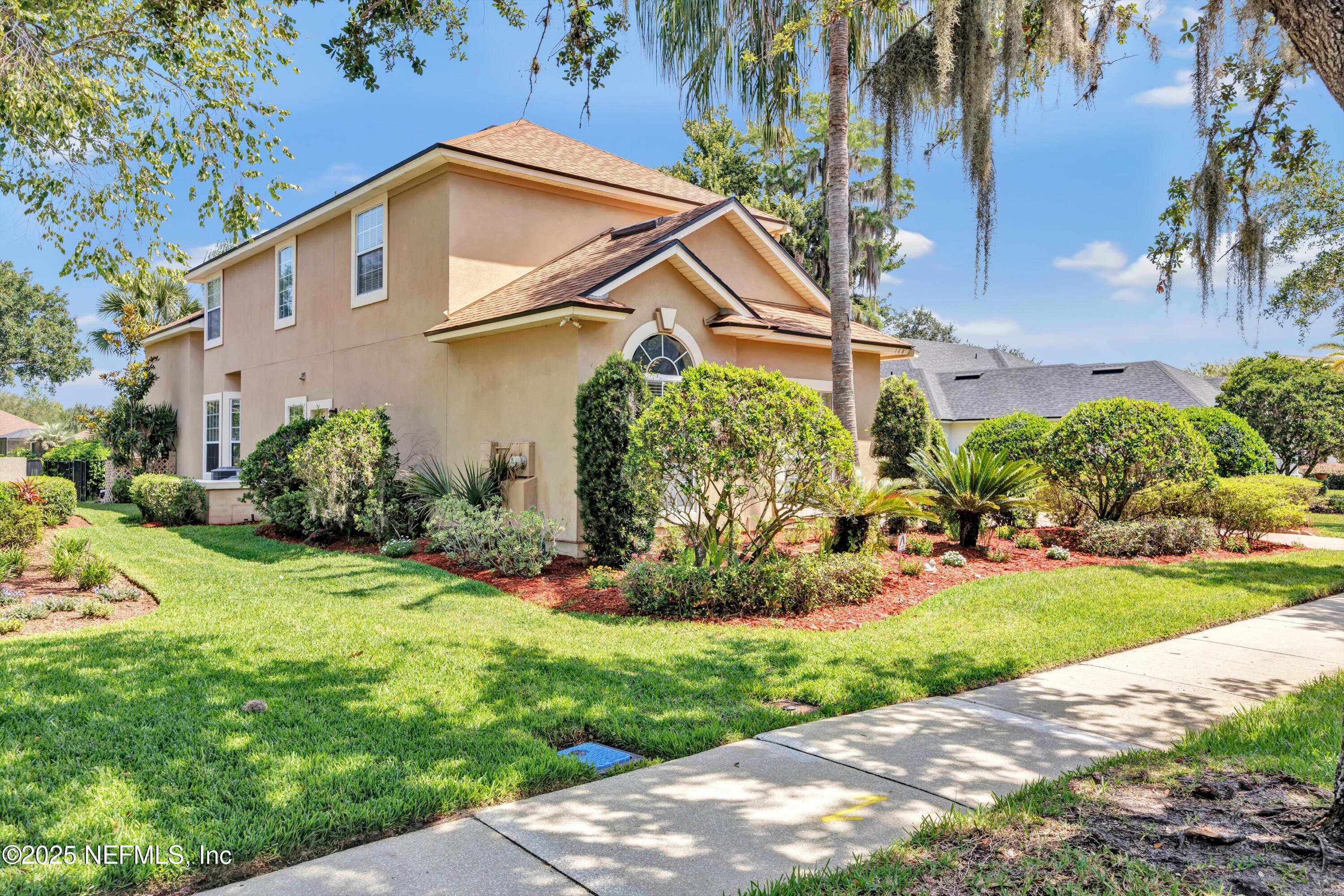 168 Pinehurst Pointe Drive St. Augustine, FL 32092 - Photo 71 of 72 a front view of a house with a yard