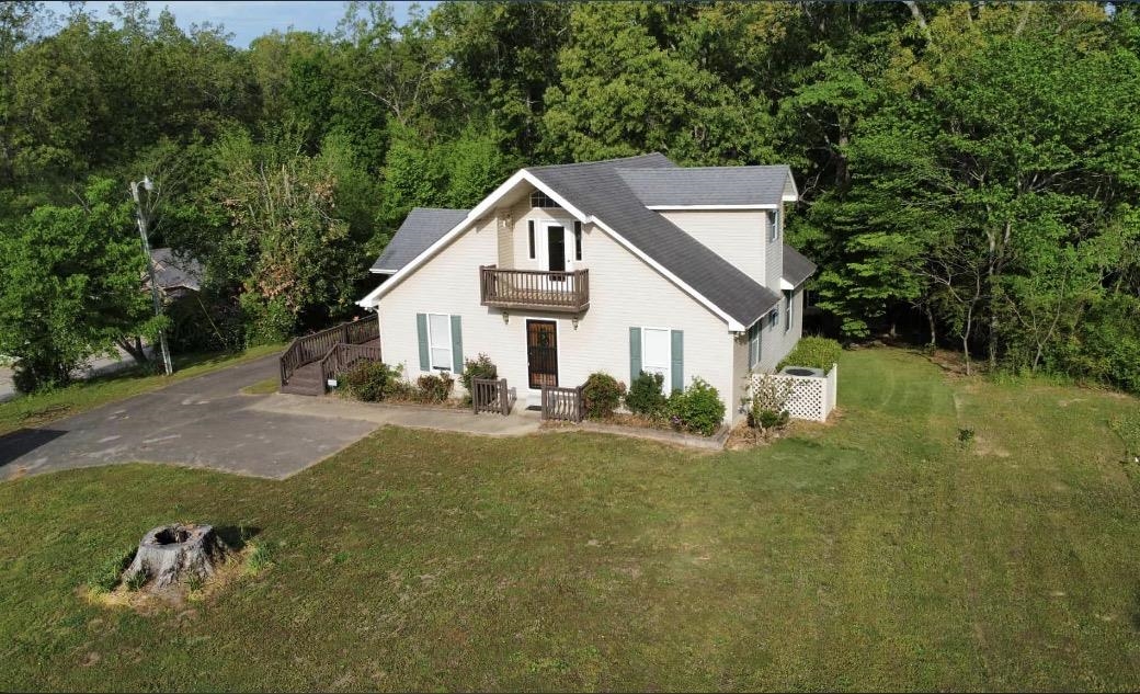 720 Riverside Lane Crump, TN 38327 - Photo 39 of 40 Two-story residence with a pitched roof, upper-level balcony, and a paved driveway
