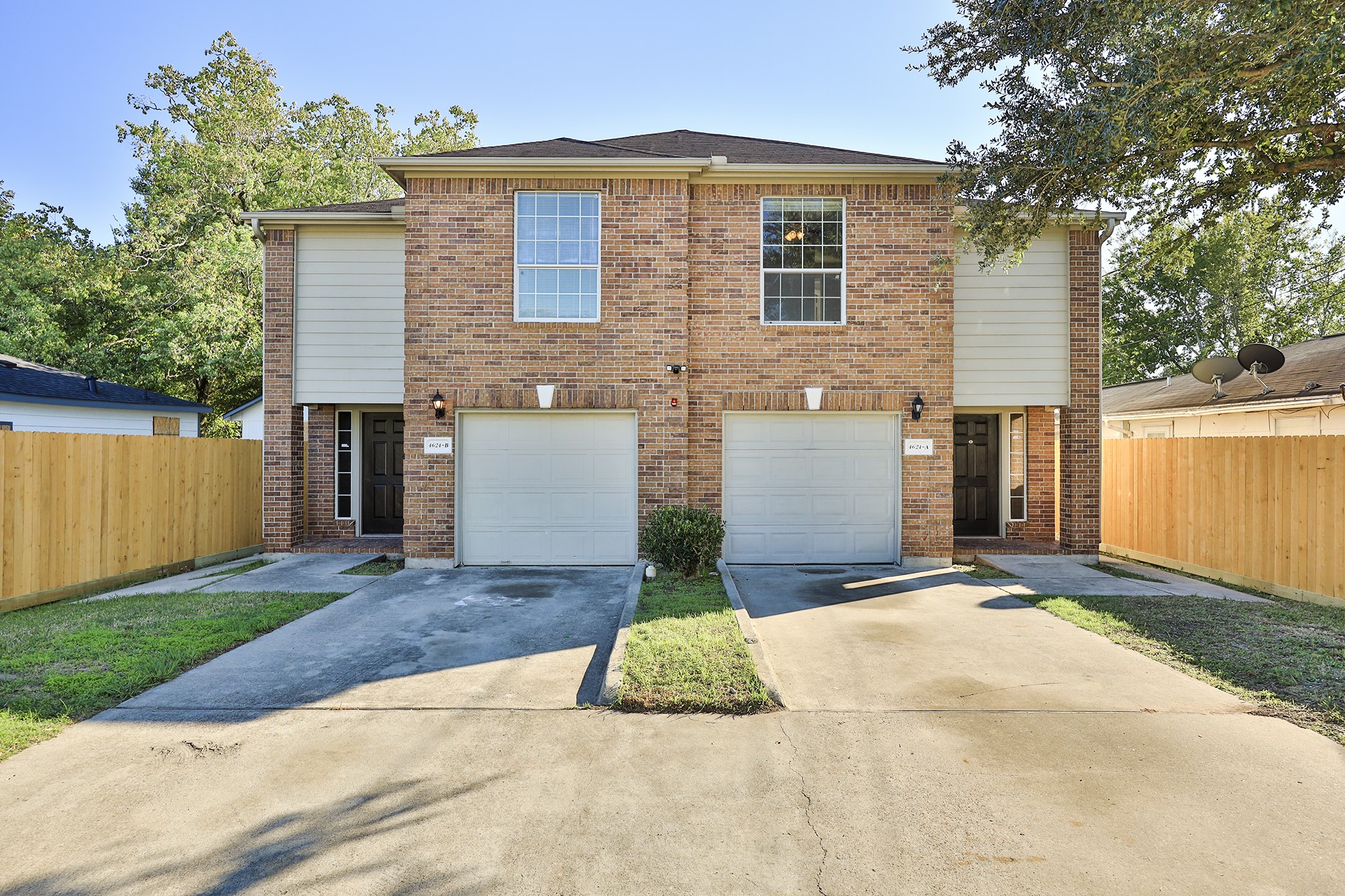 a front view of a house with a yard and a garage