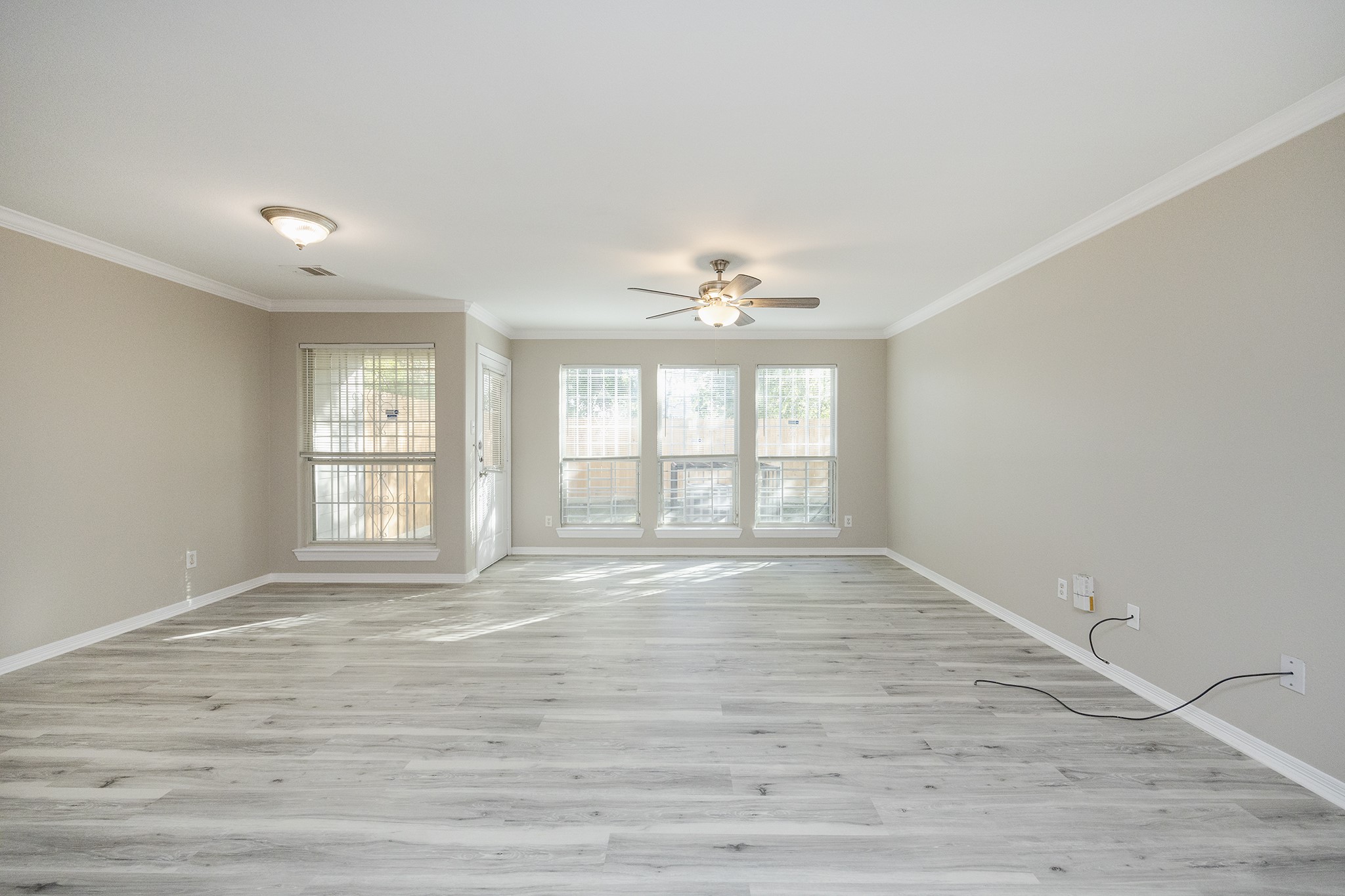 4624 Larkspur Street, Unit B Houston, TX 77051 - Photo 22 of 49 a view of an empty room with wooden floor and a window