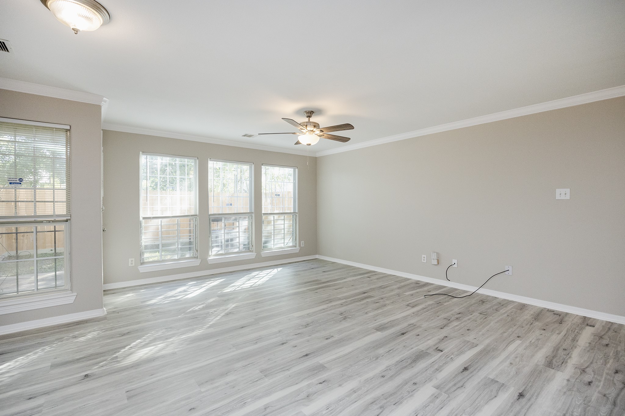 4624 Larkspur Street, Unit B Houston, TX 77051 - Photo 24 of 49 an empty room with wooden floor and windows