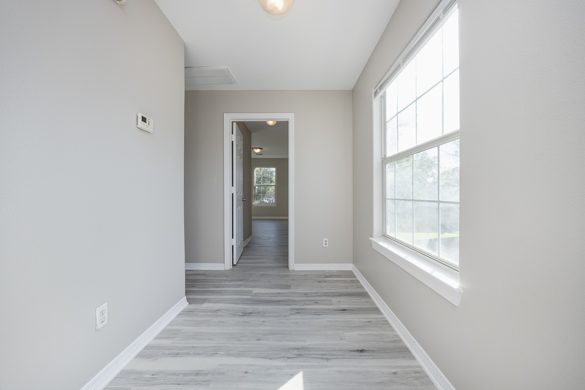 4624 Larkspur Street, Unit B Houston, TX 77051 - Photo 26 of 49 a view of a hallway with wooden floor and windows