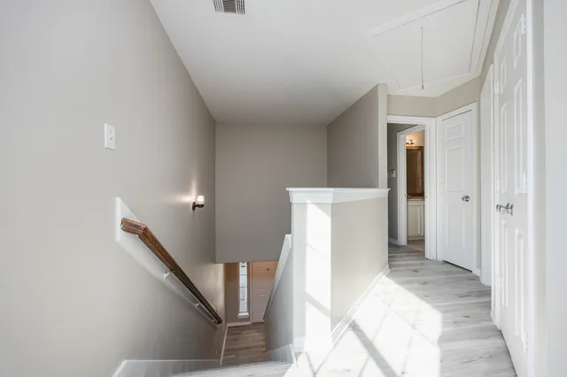 a view of entryway with furniture and wooden floor