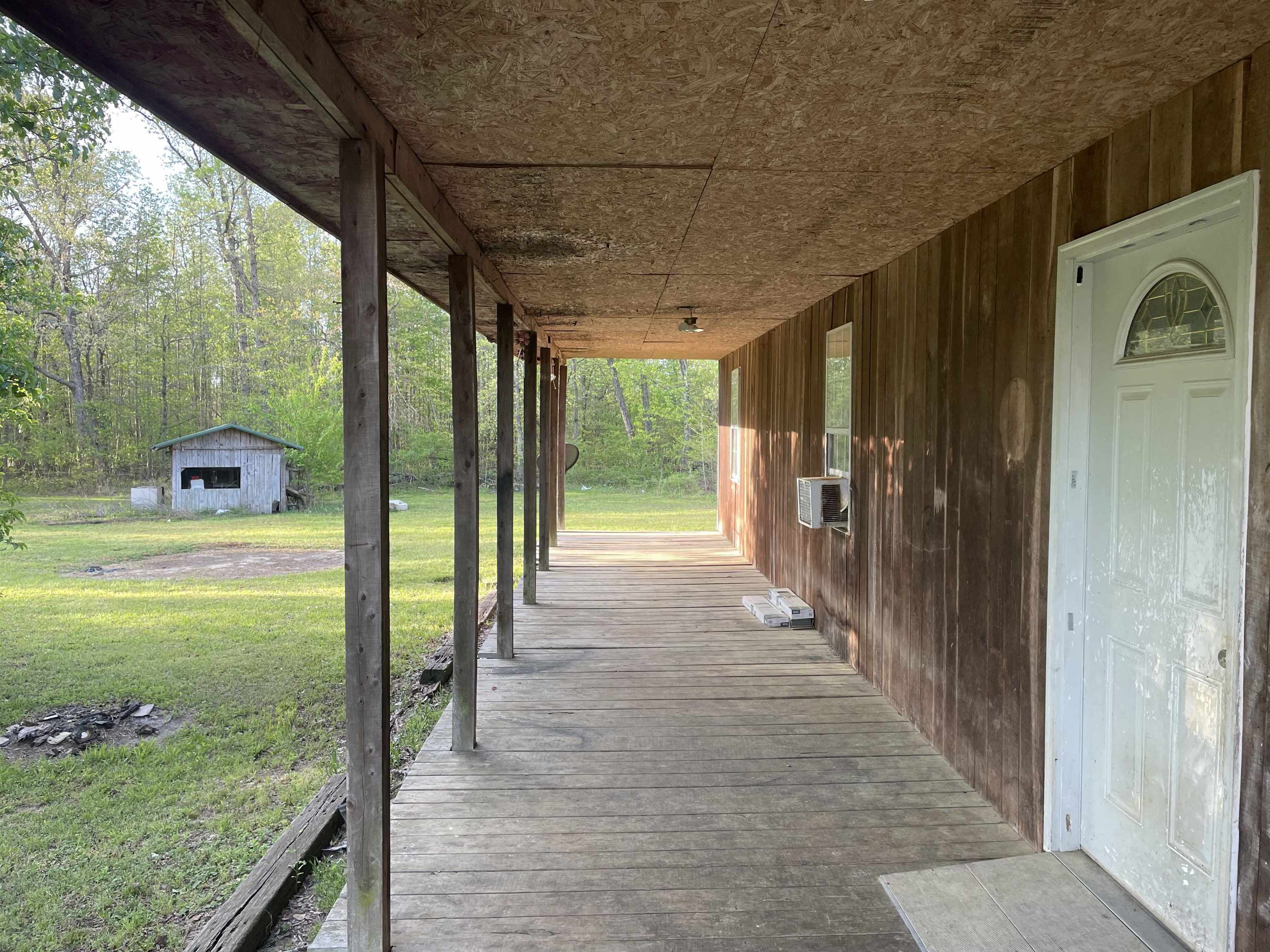 765 Foster Road Adamsville, TN 38310 - Photo 3 of 23 Wooden terrace with a lawn and cooling unit