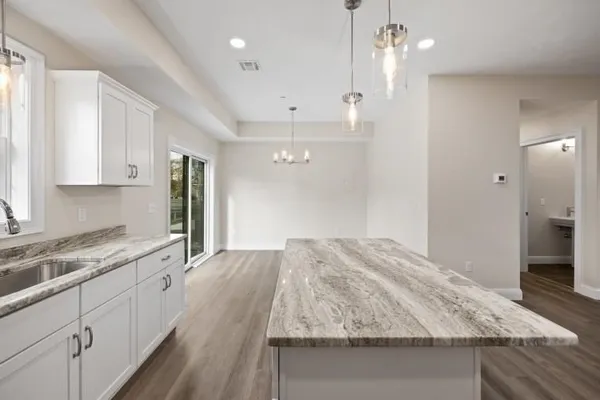 a kitchen with kitchen island a sink stainless steel appliances and cabinets