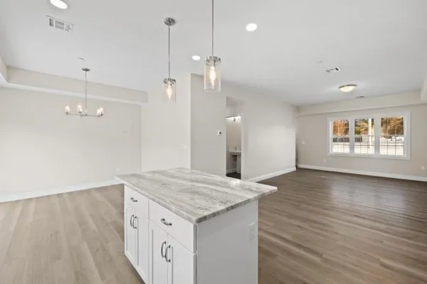 a kitchen with a wooden floor and window