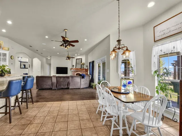 a kitchen with granite countertop white cabinets and stainless steel appliances