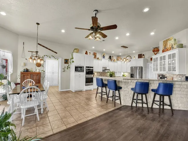 a spacious bedroom with a bed and a flat screen tv