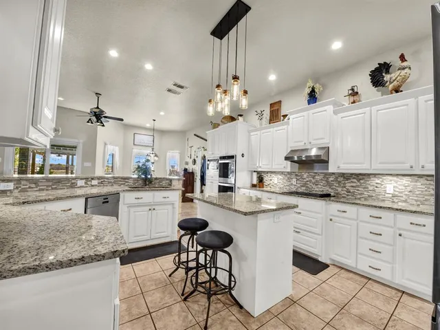 a large bathroom with a sink a large mirror and shower