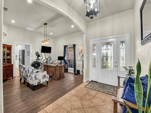 a view of a dining room with furniture wooden floor and chandelier