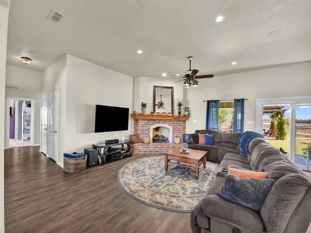 a living room with fireplace furniture and a flat screen tv