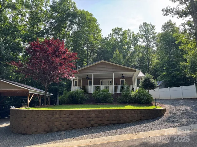 a front view of a house with a yard and trees