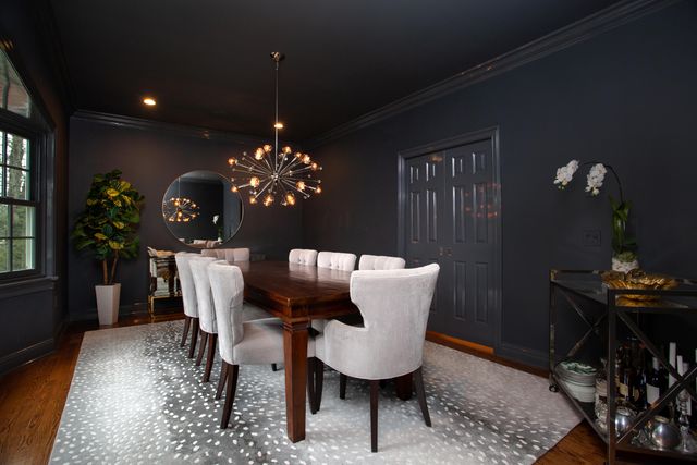 a dining room with furniture and chandelier