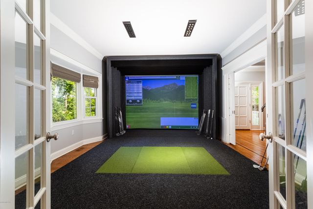 a room with pool table and windows