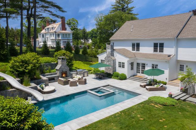 a view of a house with backyard sitting area and garden