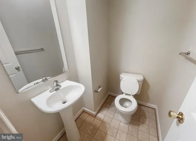a bathroom with a sink toilet and a mirror