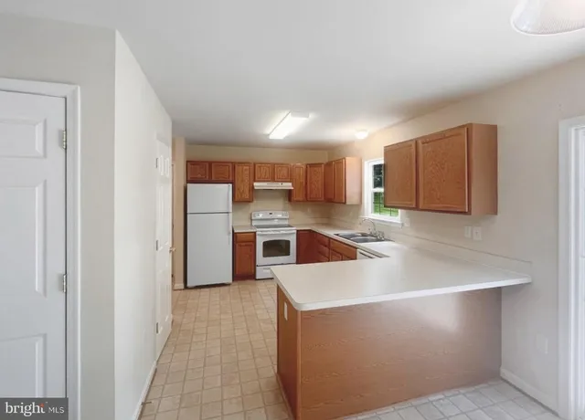 a kitchen with stainless steel appliances a refrigerator sink and microwave