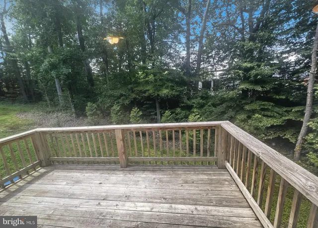 a view of balcony with wooden floor and fence