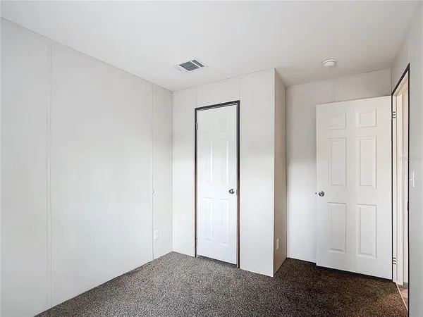 a bathroom with a granite countertop sink a toilet and a mirror