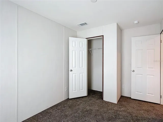 an empty room with closet area