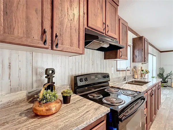 a kitchen with a stove and a wooden cabinets