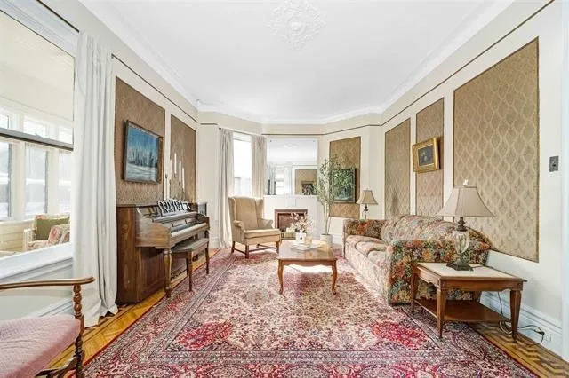 a living room with furniture rug and a table