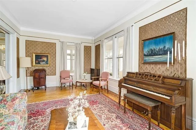a living room with furniture a fireplace and a table