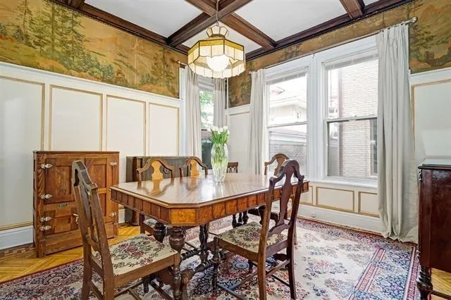 a dining room with furniture and a window