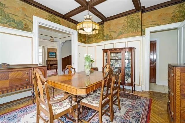 a dining room with glass top table and chairs