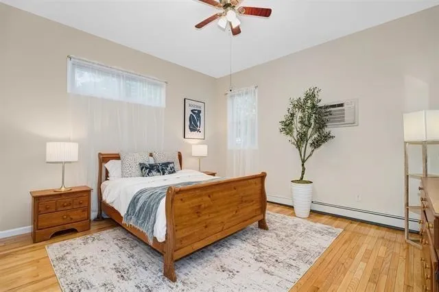 a bedroom with a bed and a potted plant