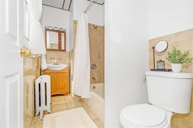 a bathroom with a toilet a sink and a mirror
