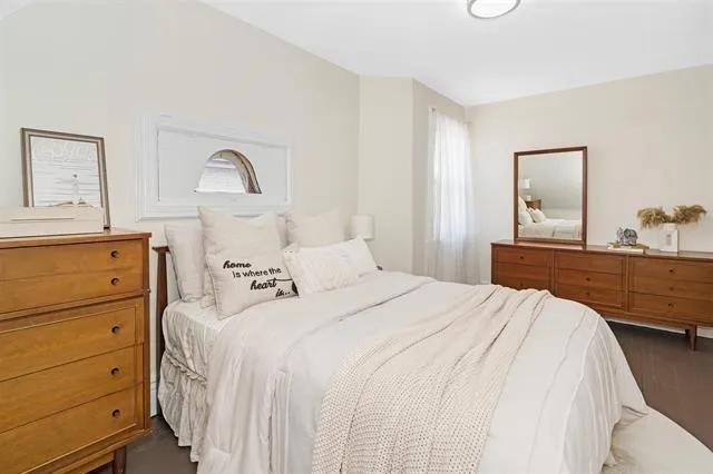 a bedroom with a bed and a dresser