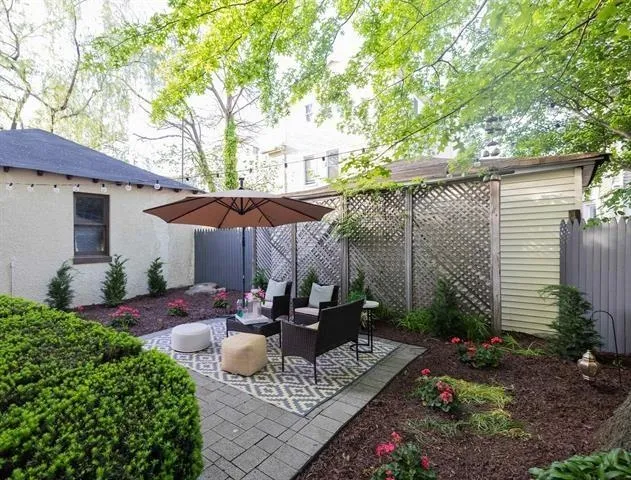 a view of backyard of house with seating space