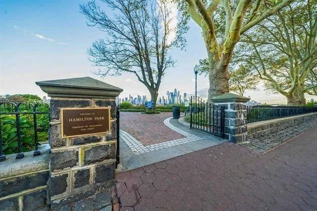 a view of backyard with barbeque oven and trees