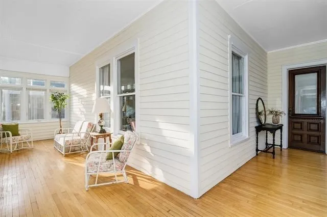 a living room with furniture and large wooden floor